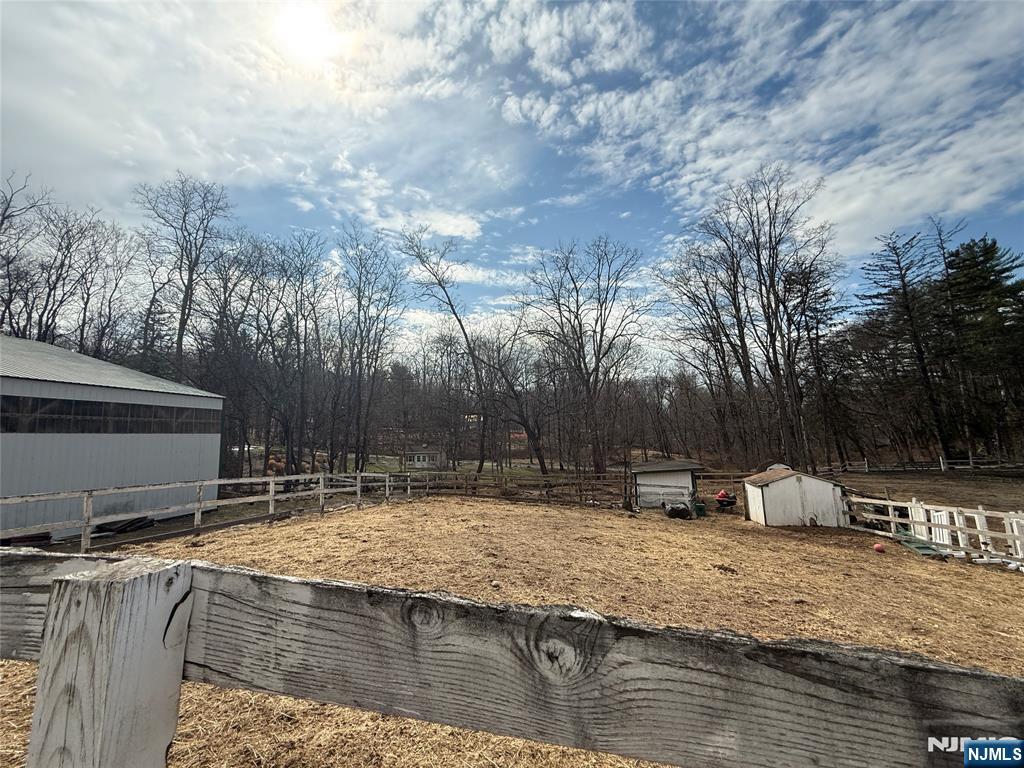 695 Ramapo Valley Road Oakland, NJ 07436 - Photo 4 of 42 a swimming pool with a yard and trees in the background