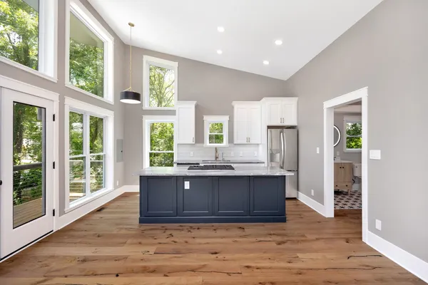 a kitchen with granite countertop a sink stove and cabinets