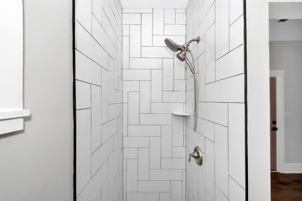an empty room with wooden floor cabinet and a ceiling fan