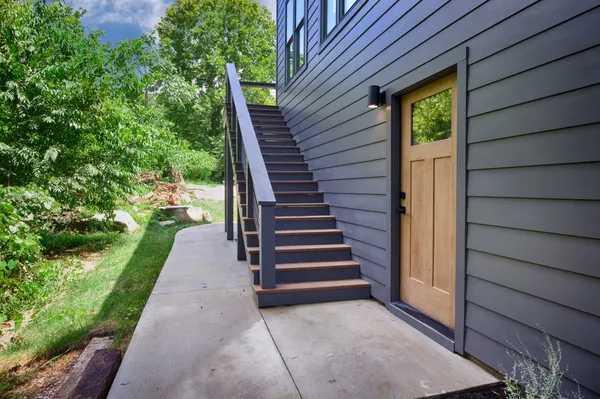 a kitchen with stainless steel appliances granite countertop a refrigerator a stove a sink dishwasher a microwave oven with cabinets and wooden floor