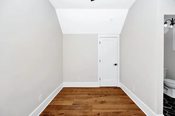 a green field with trees in the background