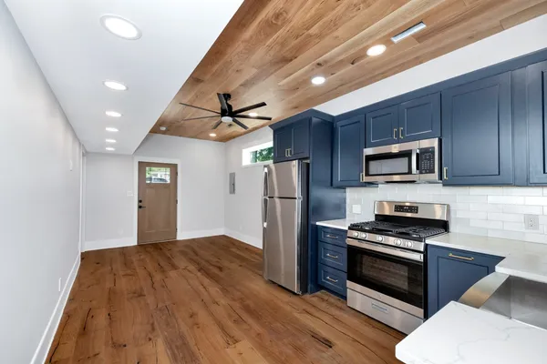 a kitchen with stainless steel appliances granite countertop a stove and a sink