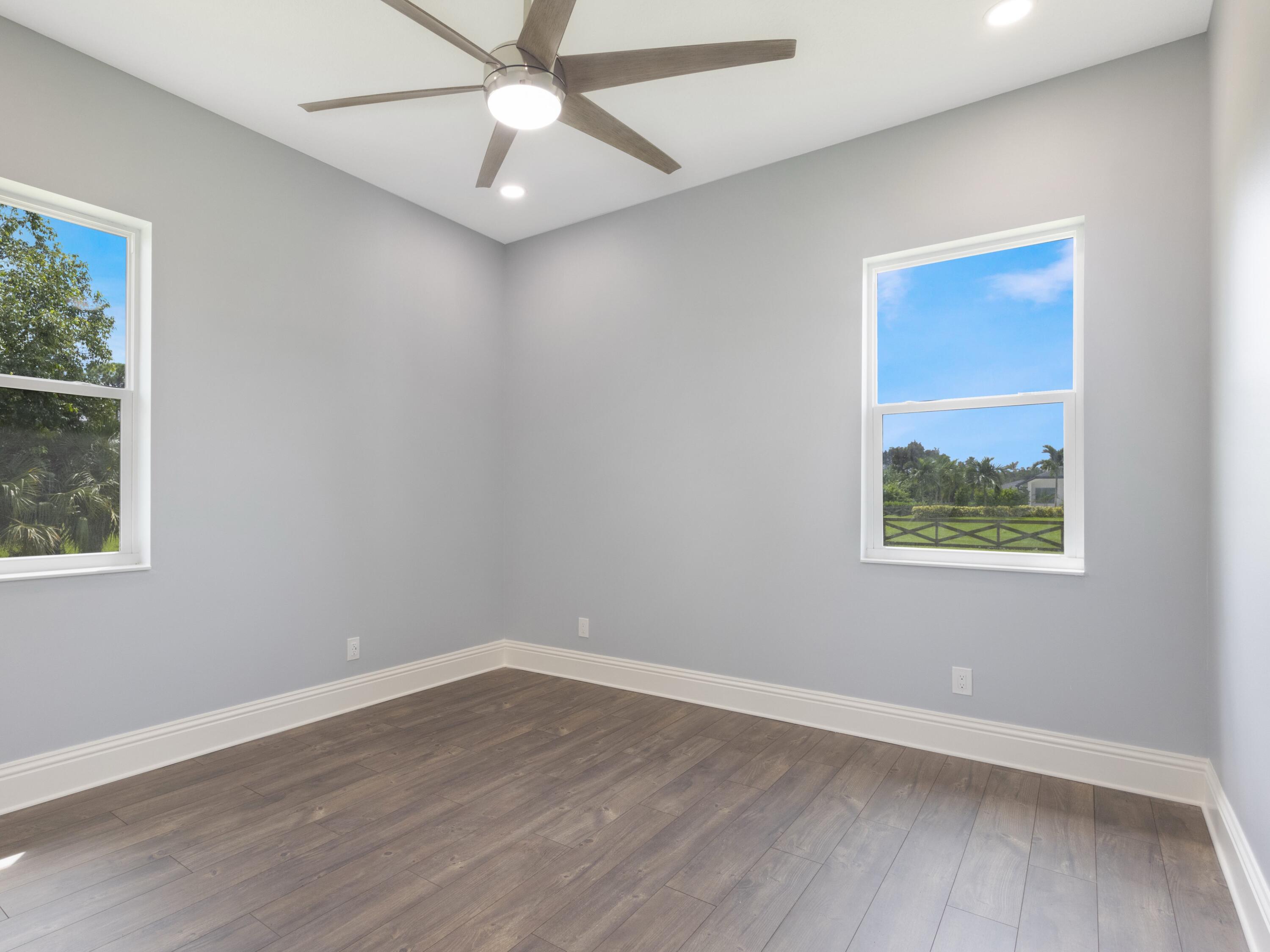 17436 71st Lane North Loxahatchee, FL 33470 - Photo 43 of 50 wooden floor in an empty room with a window