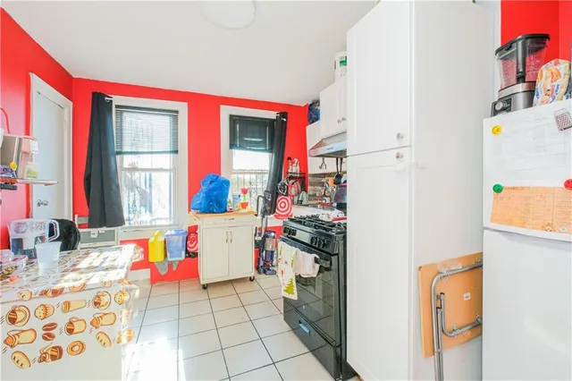 a kitchen with a refrigerator and a stove top oven