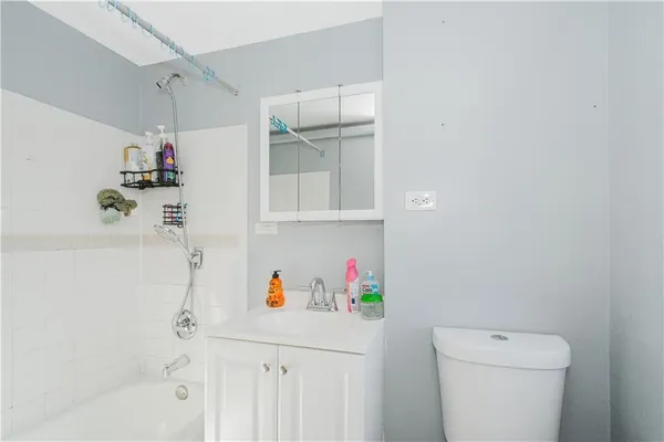 a bathroom with a toilet a sink and a mirror
