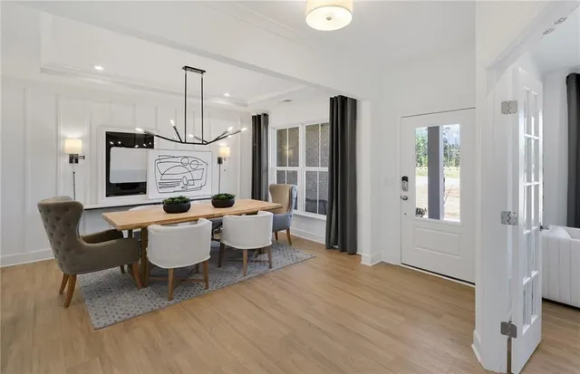a view of a dining room with furniture and wooden floor
