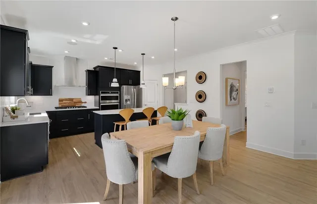 a large kitchen with a table and chairs