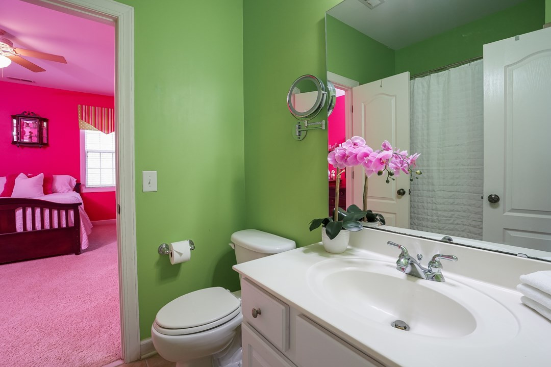 2920 Elmfield Street Raleigh, NC 27614 - Photo 25 of 30 This bathroom is between bedrooms 3 and 4. White vanity with cultured marble top, tile floors and a tiled tub/shower. Jack and Jill Bath