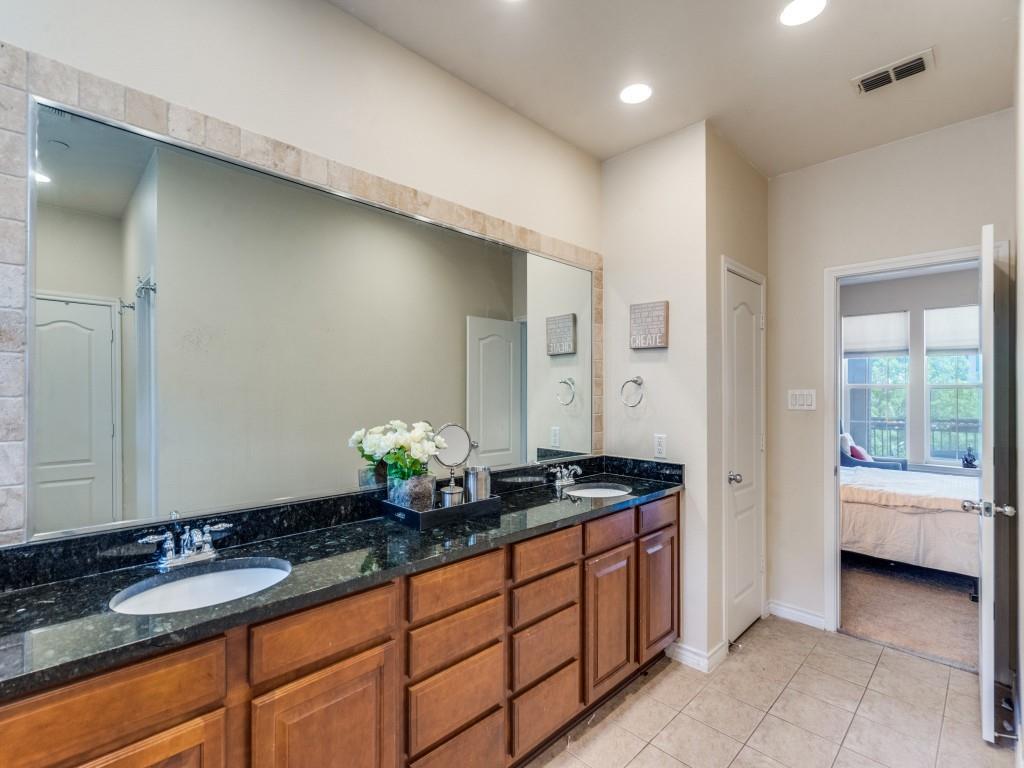 15711 Spectrum Drive, Unit 80 Addison, TX 75001 - Photo 20 of 26 a spacious bathroom with a granite countertop sink and a mirror