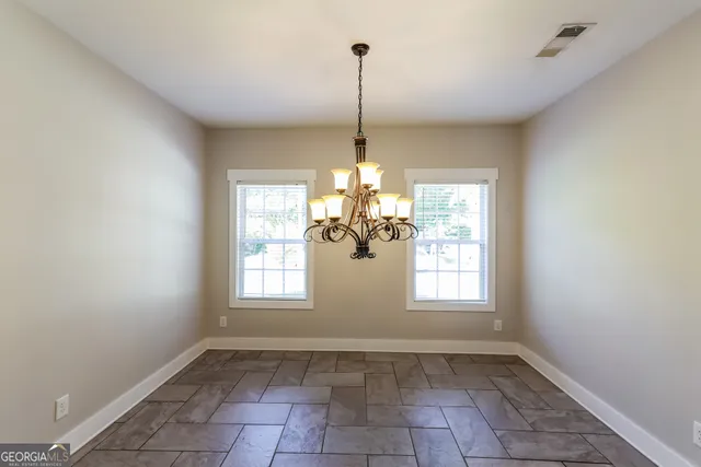 a view of an empty room with windows