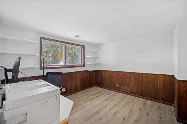 a bathroom with a sink mirror and a toilet