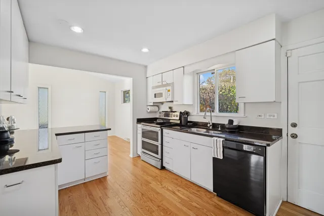 a kitchen with a sink stove top oven and refrigerator