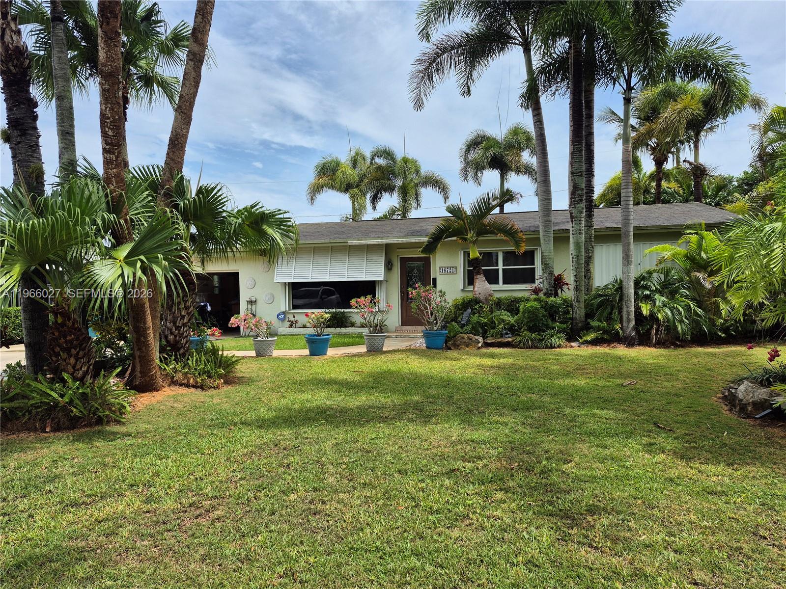 16721 Southwest 298th Terrace Homestead, FL 33030 - Photo 1 of 19 a front view of a house with garden