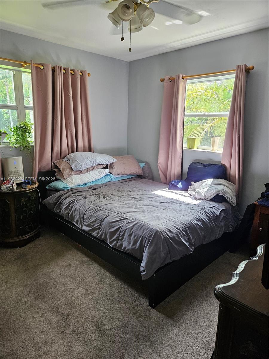16721 Southwest 298th Terrace Homestead, FL 33030 - Photo 11 of 19 a bedroom with a bed and a window
