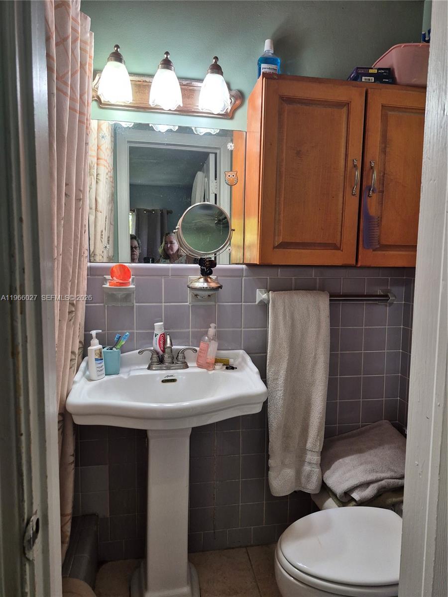 16721 Southwest 298th Terrace Homestead, FL 33030 - Photo 12 of 19 a bathroom with a sink toilet and mirror