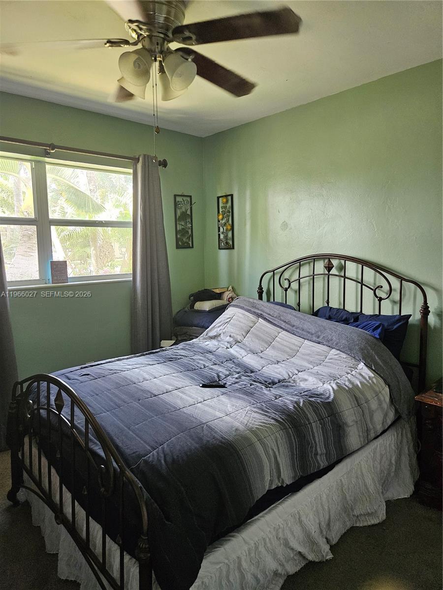 16721 Southwest 298th Terrace Homestead, FL 33030 - Photo 13 of 19 a bedroom with a bed next to a window