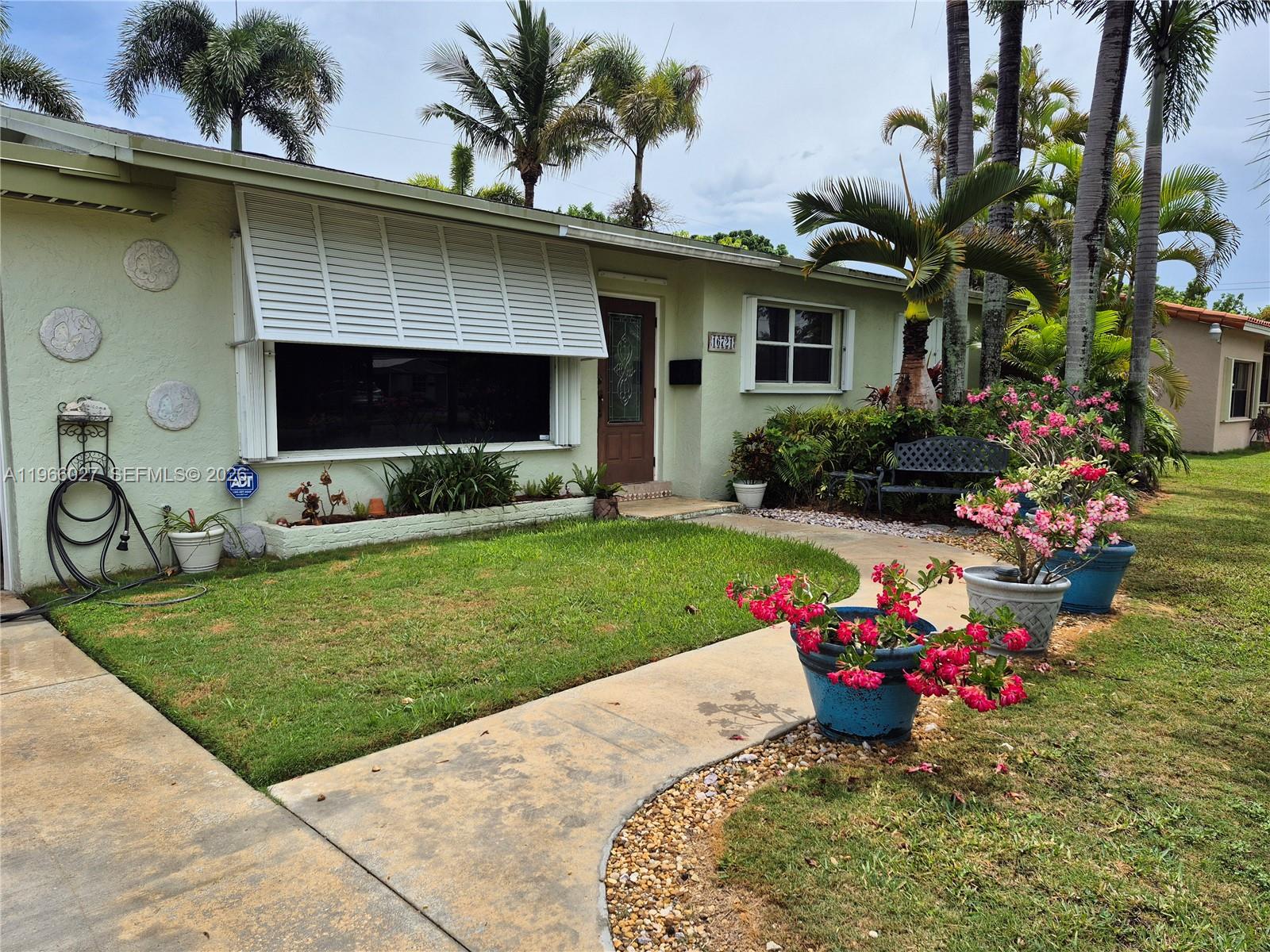 16721 Southwest 298th Terrace Homestead, FL 33030 - Photo 14 of 19 a front view of a house with a yard and a garden