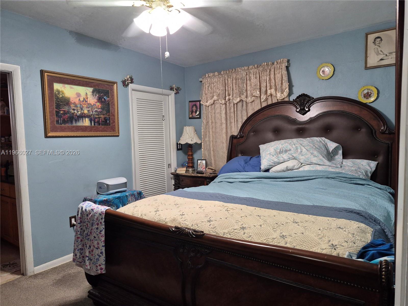 16721 Southwest 298th Terrace Homestead, FL 33030 - Photo 6 of 19 a bedroom with a bed and a chandelier