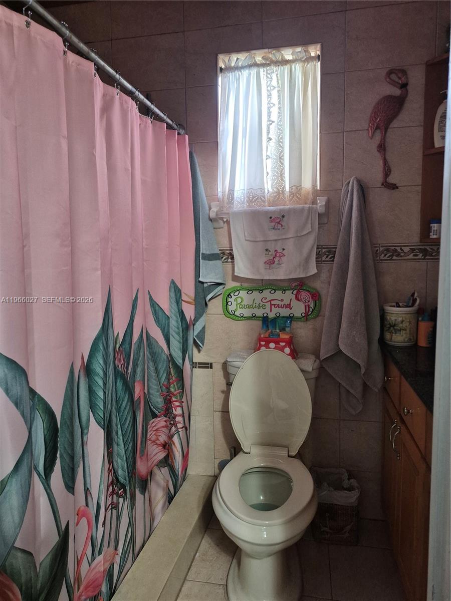 16721 Southwest 298th Terrace Homestead, FL 33030 - Photo 7 of 19 a bathroom with a toilet sink and mirror