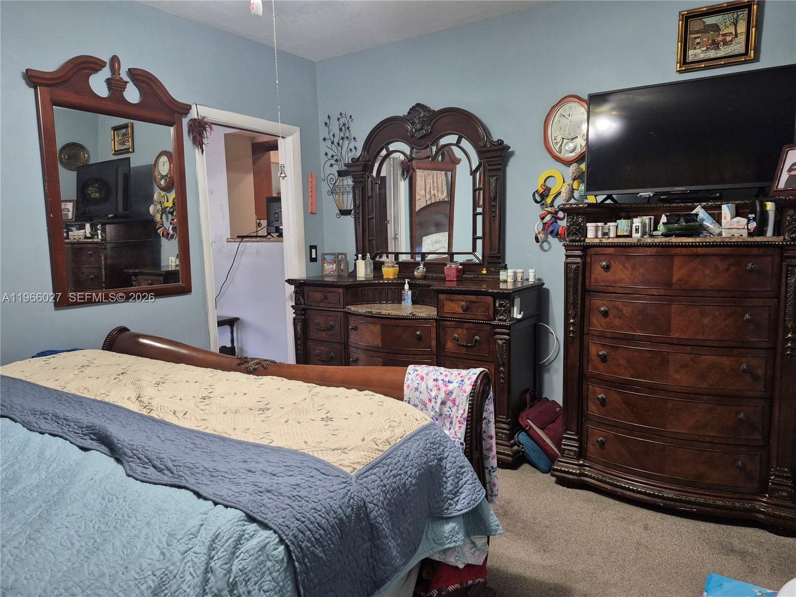 16721 Southwest 298th Terrace Homestead, FL 33030 - Photo 8 of 19 a bedroom with a bed and a flat screen television