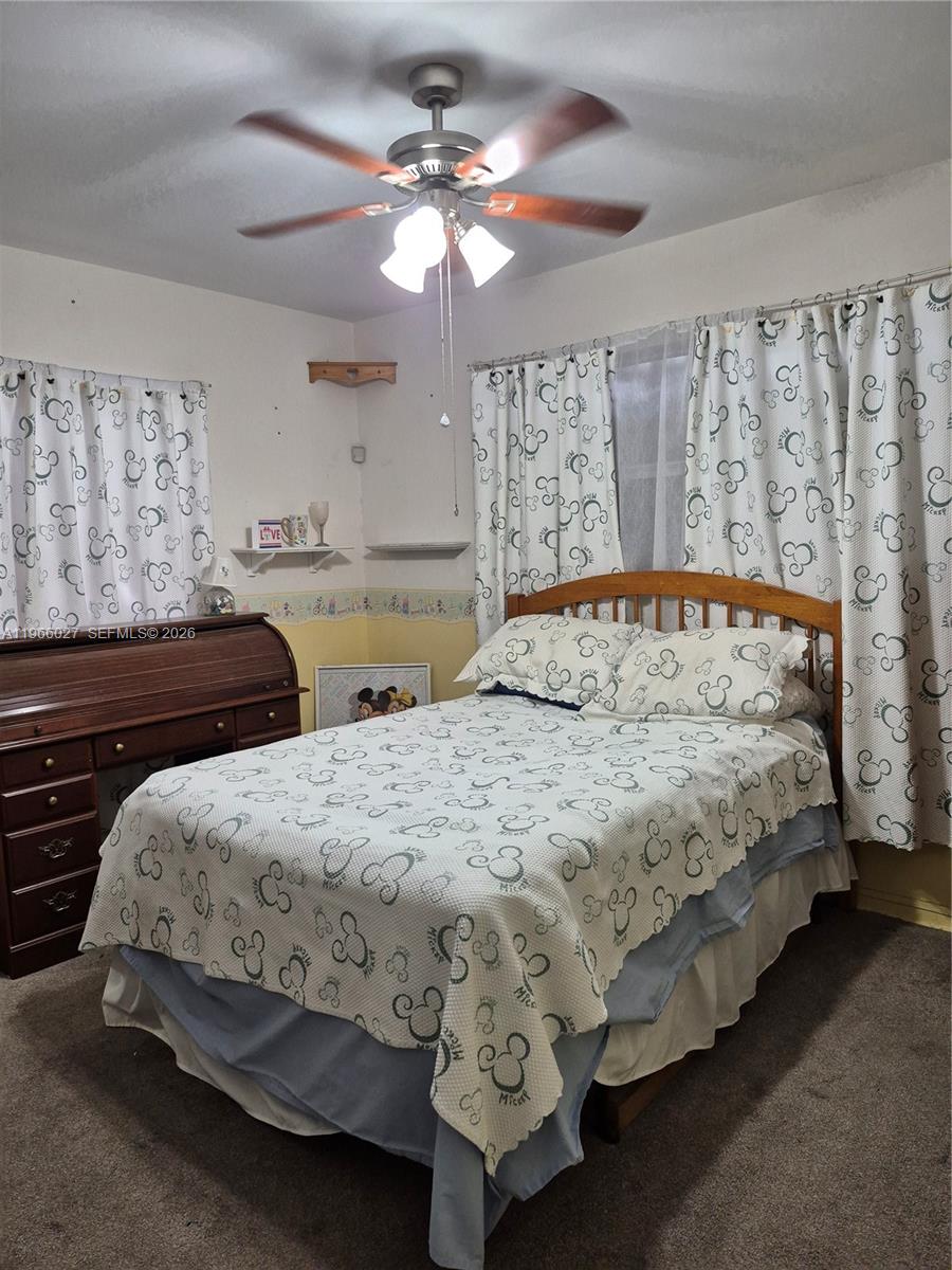 16721 Southwest 298th Terrace Homestead, FL 33030 - Photo 9 of 19 a bedroom with a bed and a chandelier