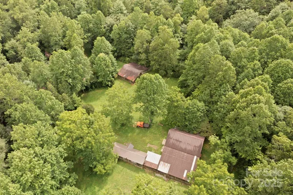an aerial view of a house with a yard