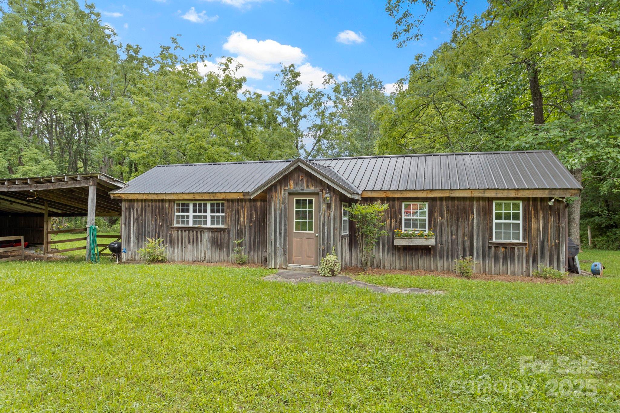 0 South Bobs Creek Road Zirconia, NC 28790 - Photo 3 of 31 a front view of a house with garden