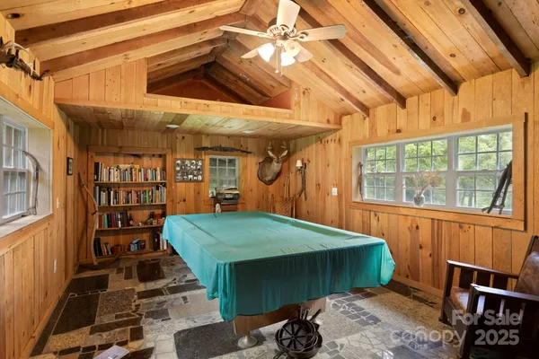 a room with lots of wooden furniture and a window