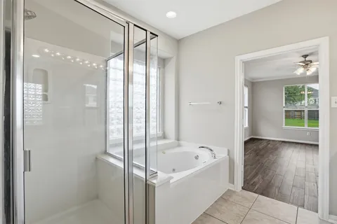 a bathroom with a bathtub and a shower