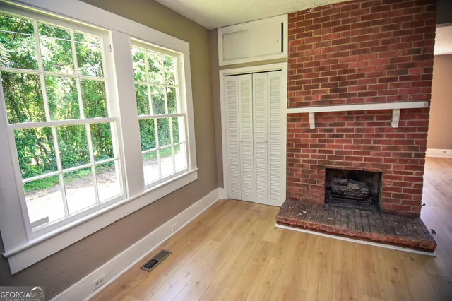 a living room with a fireplace and windows