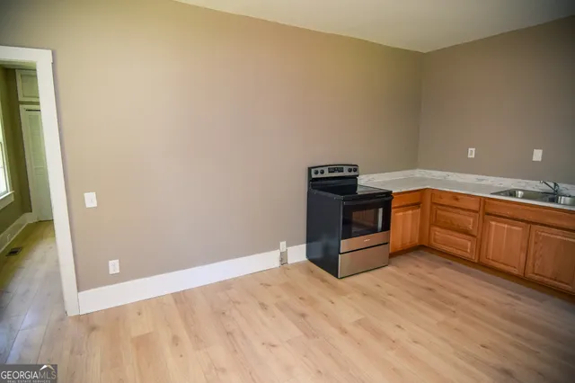 a kitchen with stainless steel appliances wooden cabinets and a sink
