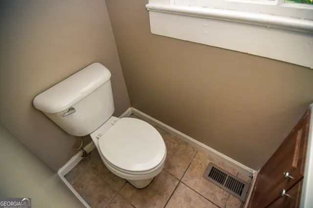 a white toilet sitting next to a white sink