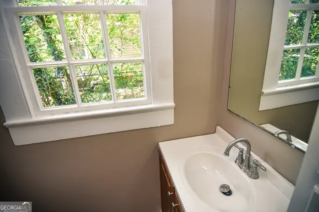 a bathroom with a sink and a window