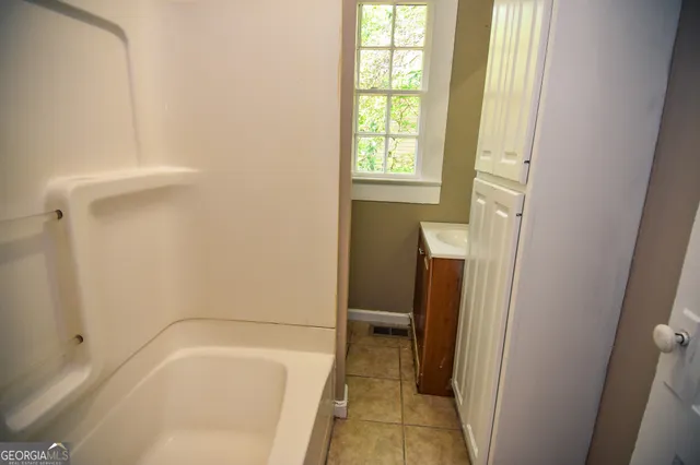 a bathroom with a tub and a shower