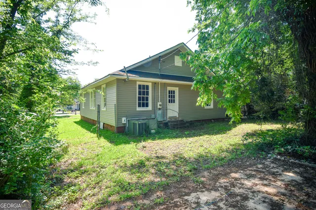 a view of backyard with a garden and trees