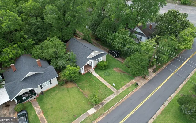 an aerial view of a golf course with street