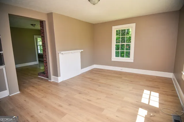 an empty room with windows and closet