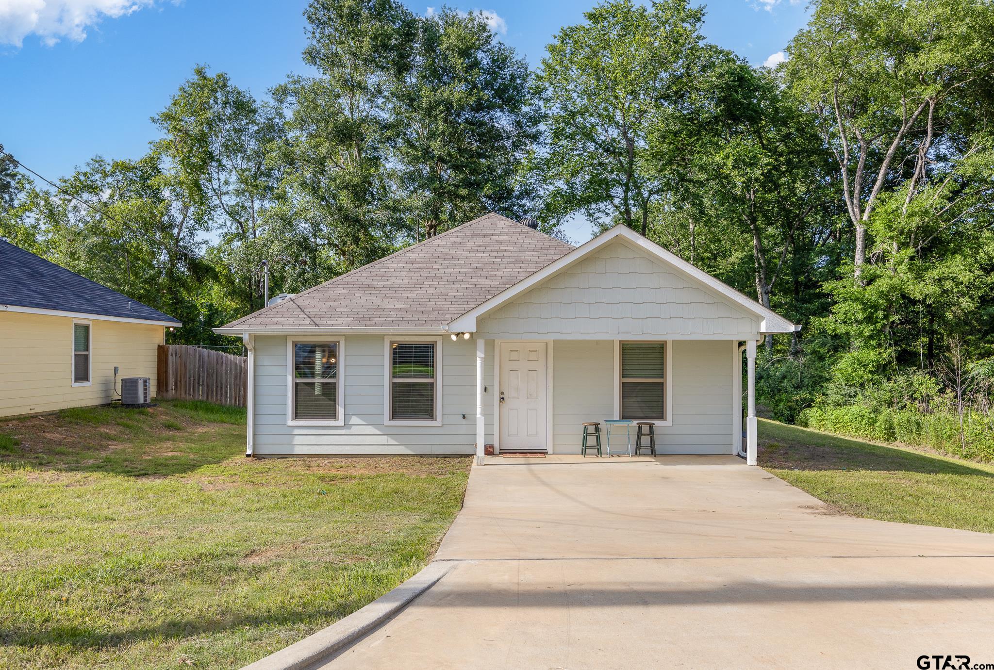 421 Alexander Street Kilgore, TX 75662 - Photo 1 of 24 a view of a yard in front of a house with large tree