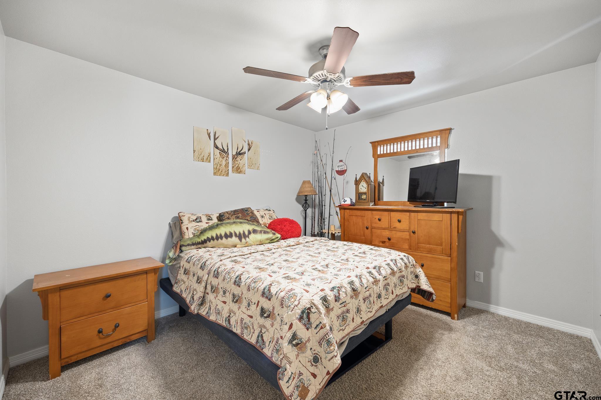 421 Alexander Street Kilgore, TX 75662 - Photo 15 of 24 a bedroom with a bed and a chandelier