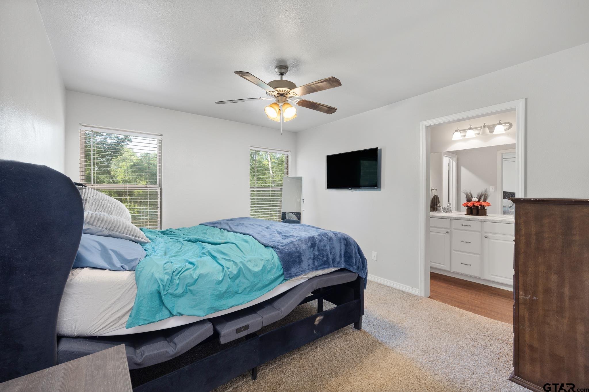 421 Alexander Street Kilgore, TX 75662 - Photo 18 of 24 a bed room with a bed window and a flat screen tv