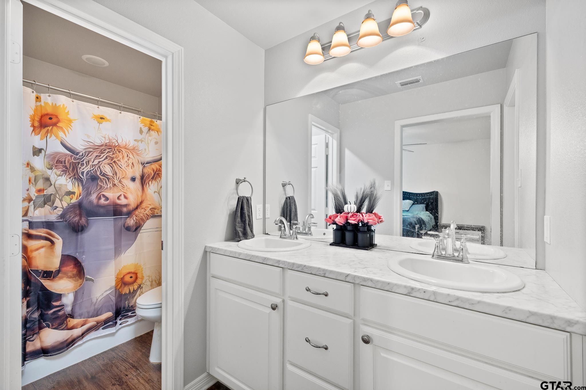 421 Alexander Street Kilgore, TX 75662 - Photo 20 of 24 a bathroom with a double vanity sink mirror and vanity