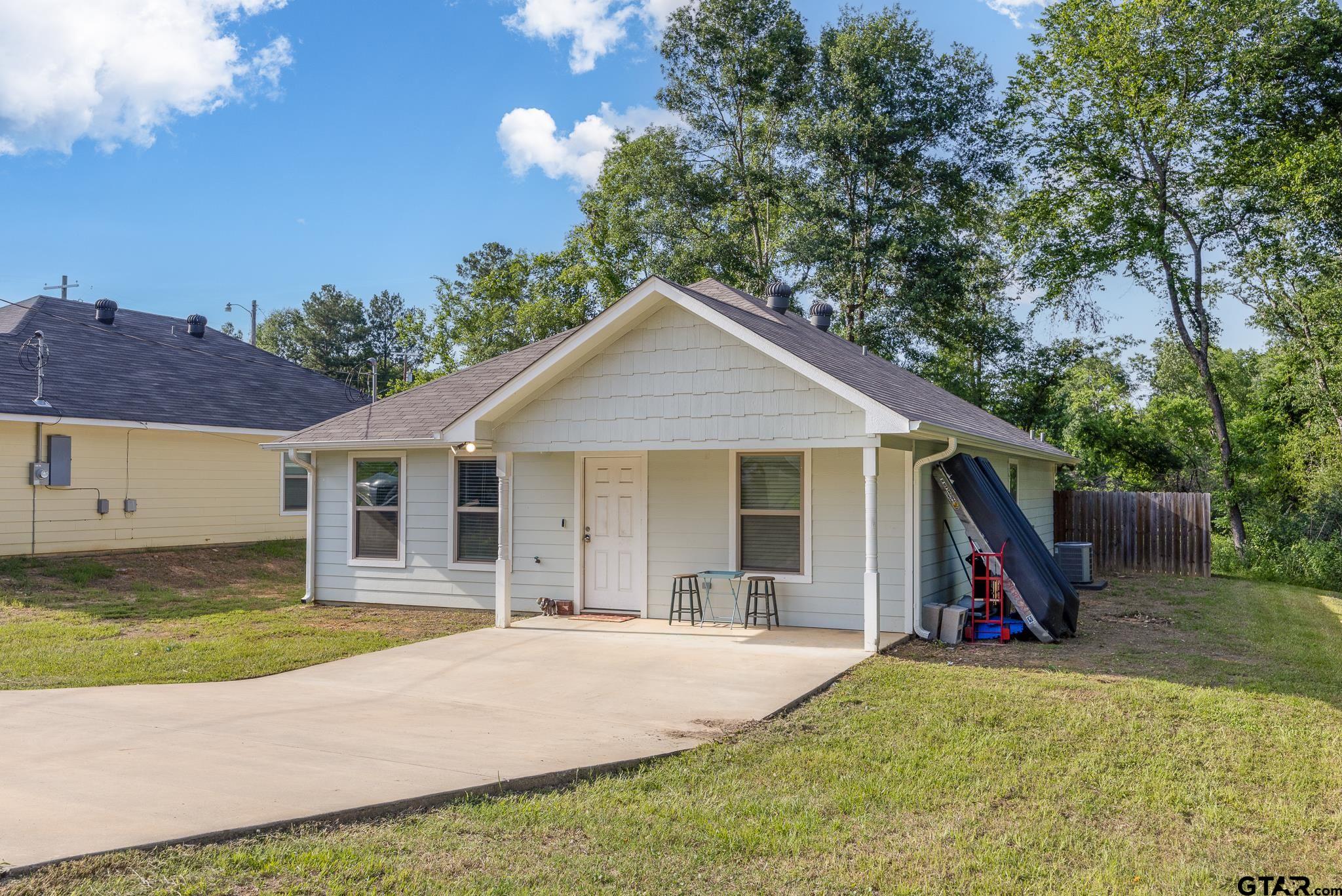 421 Alexander Street Kilgore, TX 75662 - Photo 3 of 24 a view of a house with a yard and potted plants