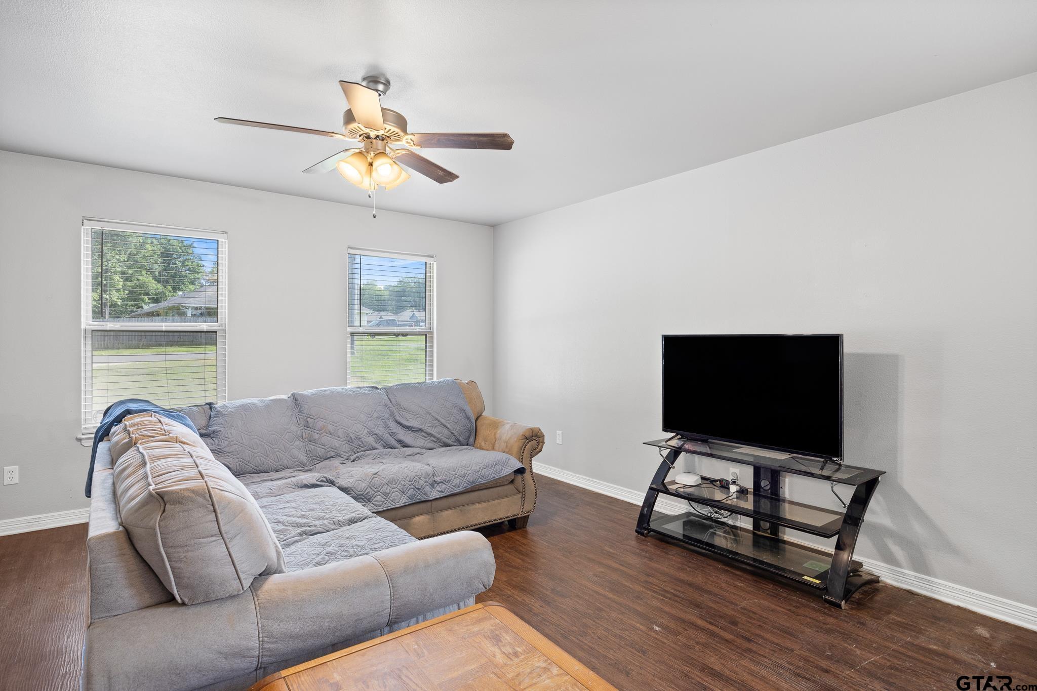421 Alexander Street Kilgore, TX 75662 - Photo 7 of 24 a living room with furniture and a flat screen tv