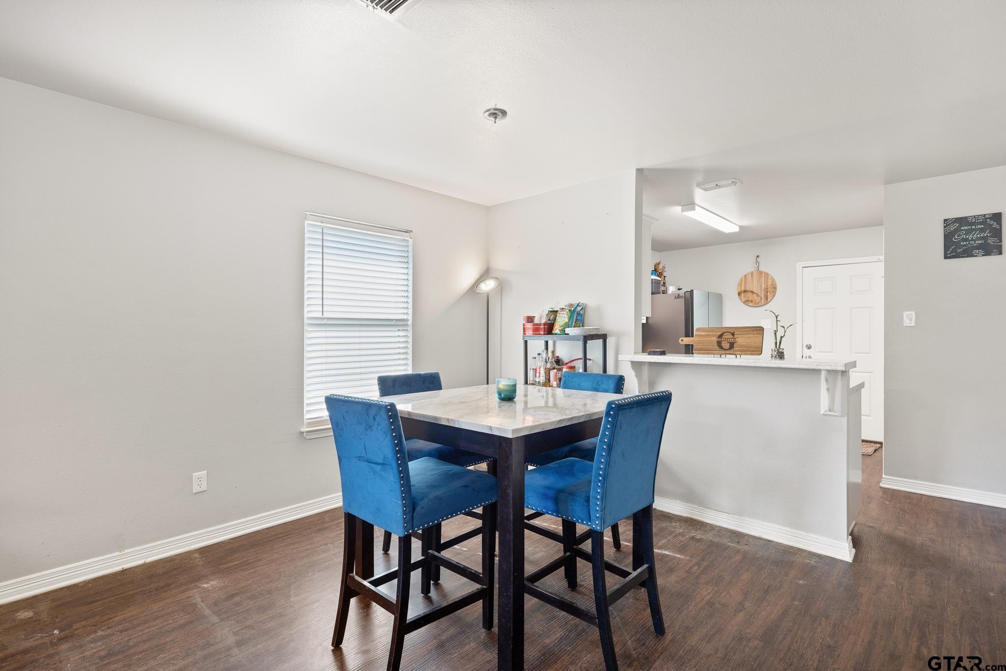 421 Alexander Street Kilgore, TX 75662 - Photo 8 of 24 a view of a dining room with furniture and wooden floor