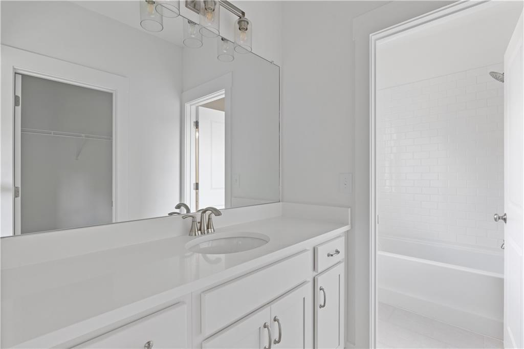 15 Overview Court Hoschton, GA 30548 - Photo 9 of 16 a bathroom with a sink and a mirror