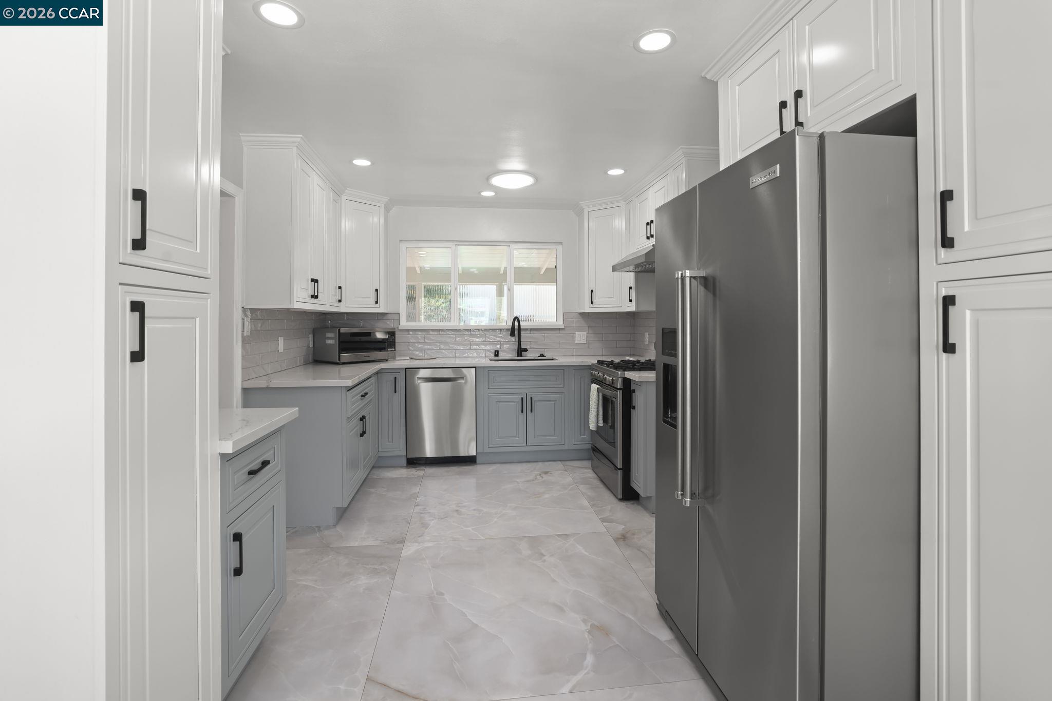1051 San Rafael Street San Leandro, CA 94577 - Photo 14 of 26 a kitchen with stainless steel appliances a refrigerator sink and cabinets
