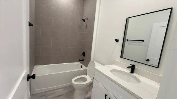 a bathroom with a toilet and a bath tub