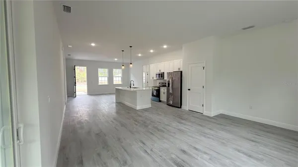 a kitchen with stainless steel appliances a stove microwave and refrigerator