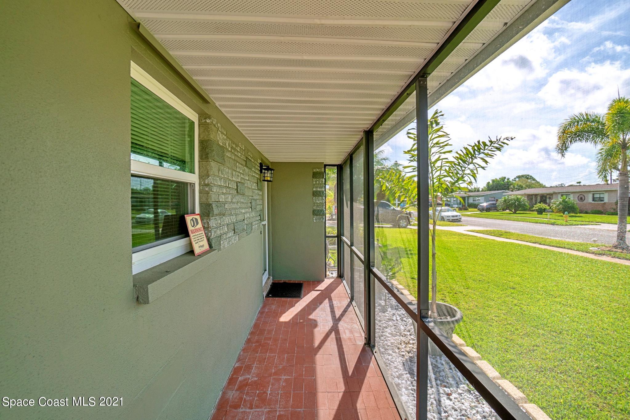 1096 Madrid Road Rockledge, FL 32955 - Photo 7 of 41 a balcony with view of an ocean