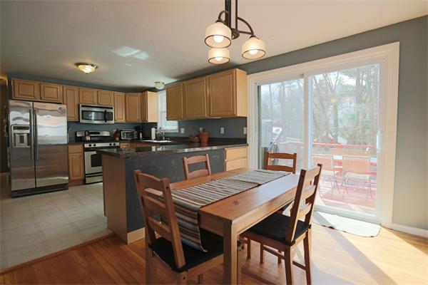 4 Arch Road Holbrook, MA 02343 - Photo 5 of 15 a kitchen with stainless steel appliances granite countertop a stove a refrigerator a kitchen island a table and chairs